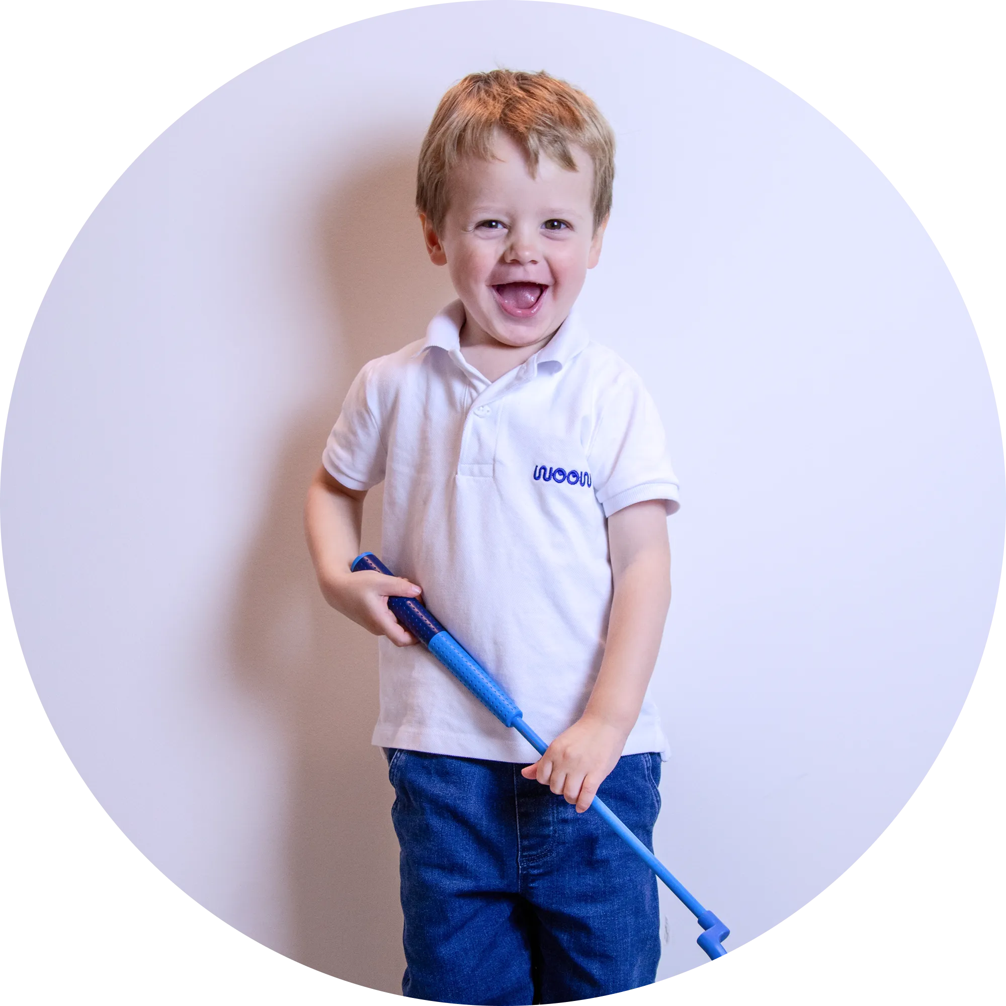 Child wearing a white polo shirt with a logo, holding a blue golf putter against a light purple background