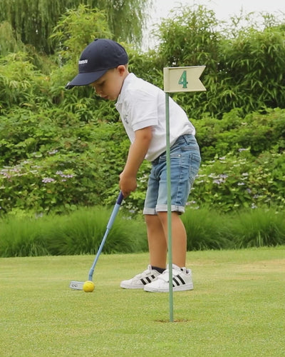 4 year old kid playing golf 